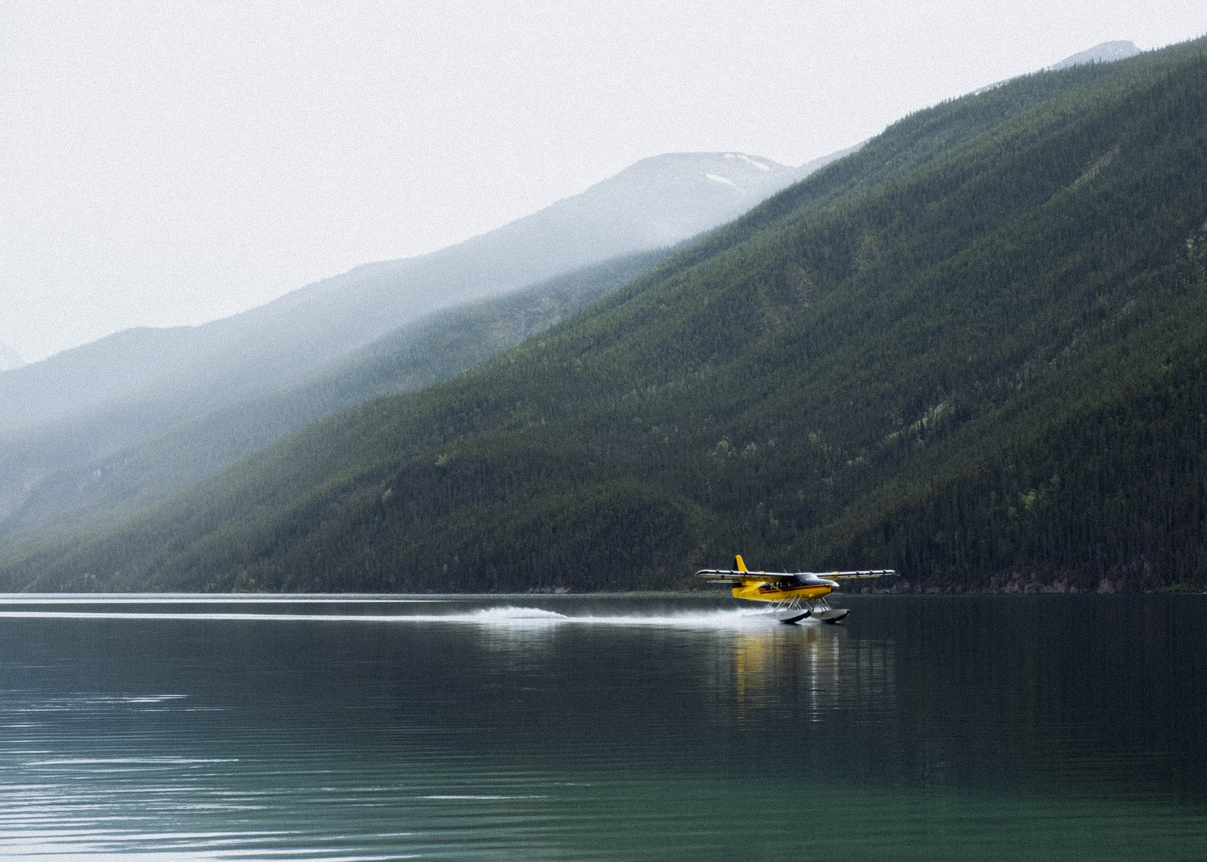 Northern Rockies Lodge floatplane landing on Muncho Lake