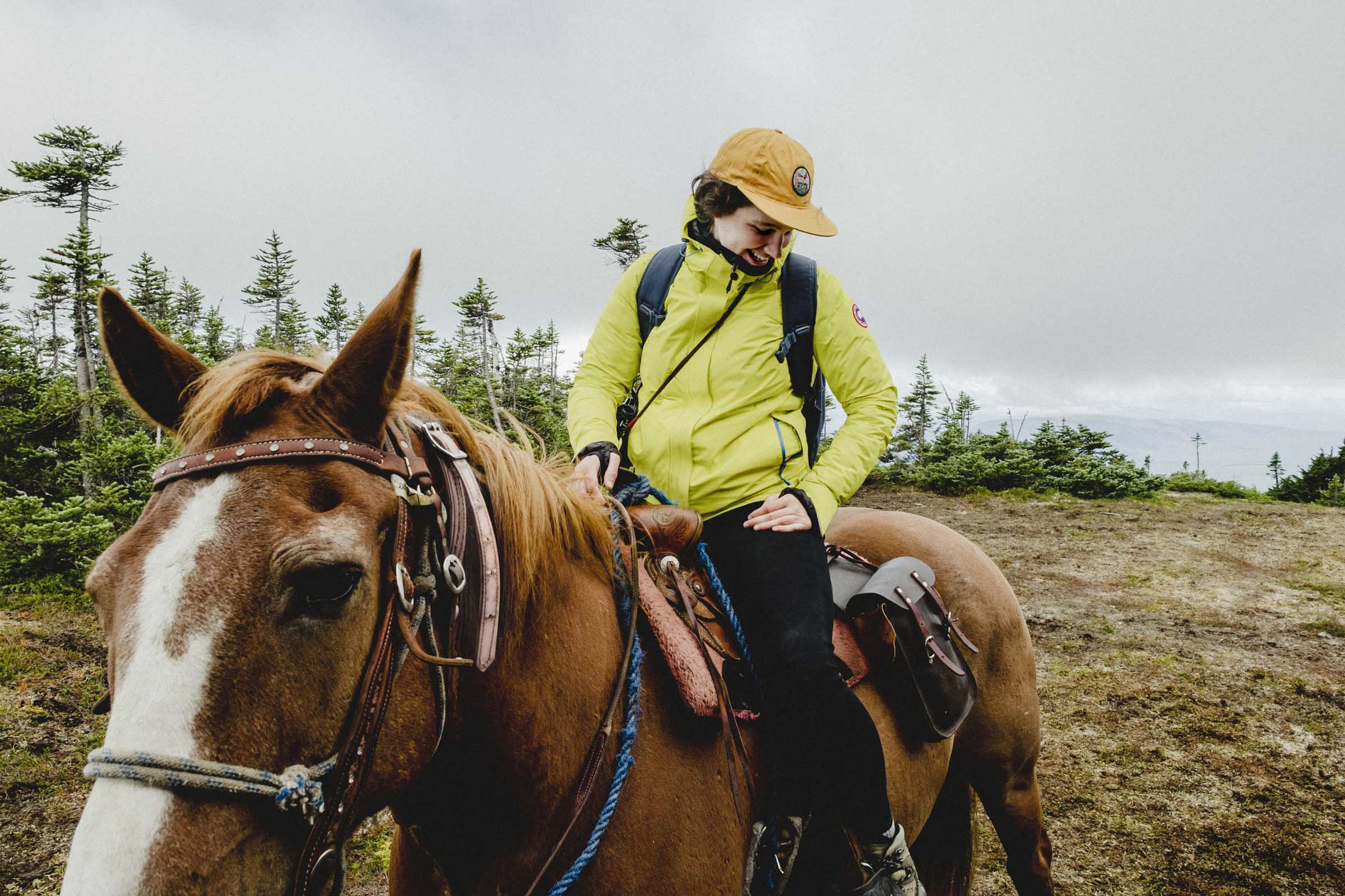 Megan horseback riding in the mountains of Northern BC